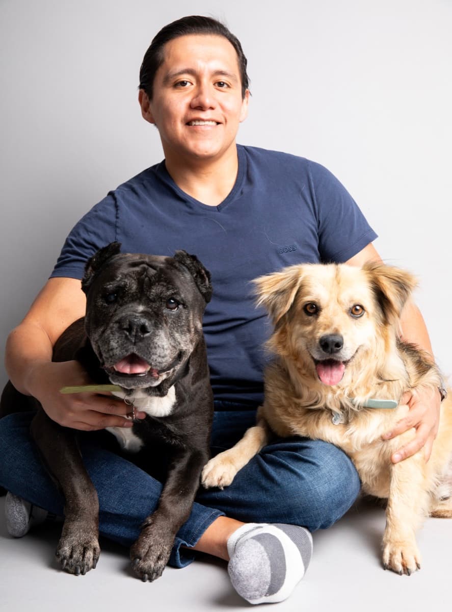 Omar Dominguez, founder of PawConscious, with his dogs Truta and Corcho